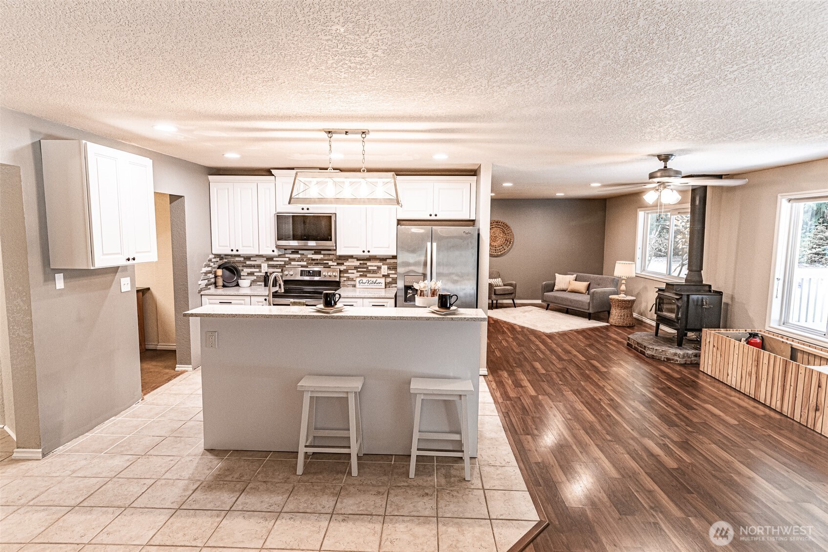 660 Peter Hagen Road West Seabeck, WA 98380 - Photo 17 of 39 a dining hall with stainless steel appliances kitchen island granite countertop a sink and cabinets