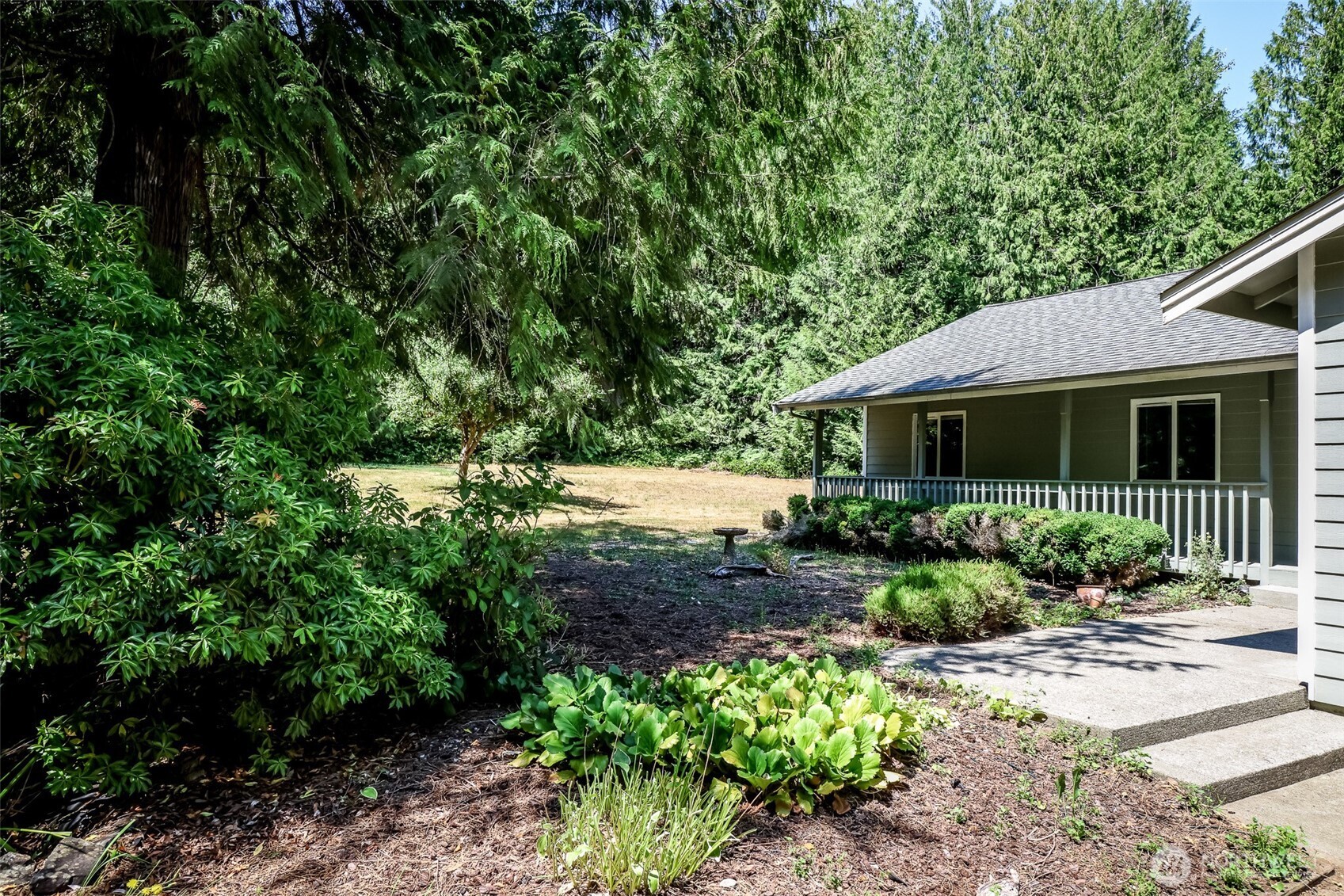 660 Peter Hagen Road West Seabeck, WA 98380 - Photo 2 of 39 a front view of a house with a yard