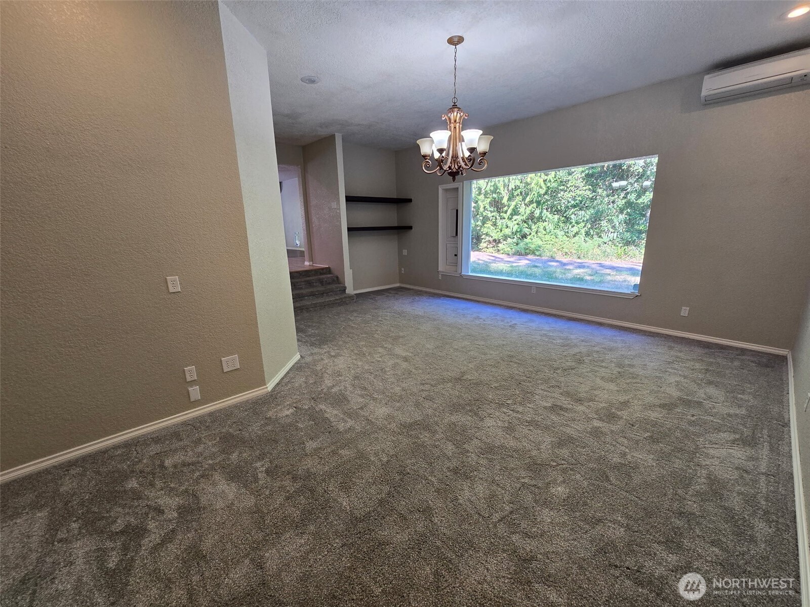 660 Peter Hagen Road West Seabeck, WA 98380 - Photo 21 of 39 an empty room with a windows and chandelier