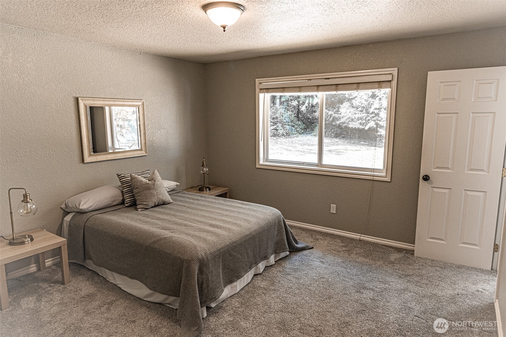 660 Peter Hagen Road West Seabeck, WA 98380 - Photo 27 of 39 a bedroom with a bed and window