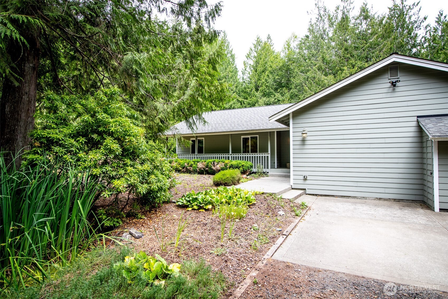 660 Peter Hagen Road West Seabeck, WA 98380 - Photo 3 of 39 a front view of a house with a yard and porch