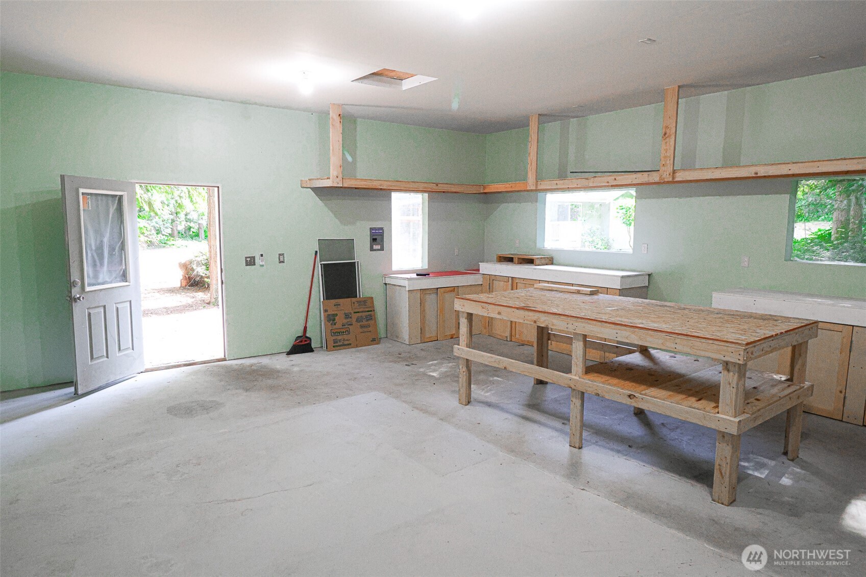 660 Peter Hagen Road West Seabeck, WA 98380 - Photo 33 of 39 a kitchen with a stove a refrigerator and cabinets