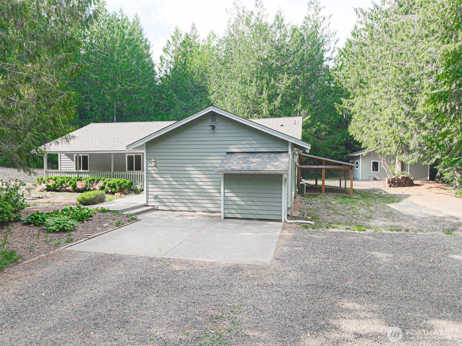 660 Peter Hagen Road West Seabeck, WA 98380 - Photo 36 of 39 a front view of a house with a yard and garage