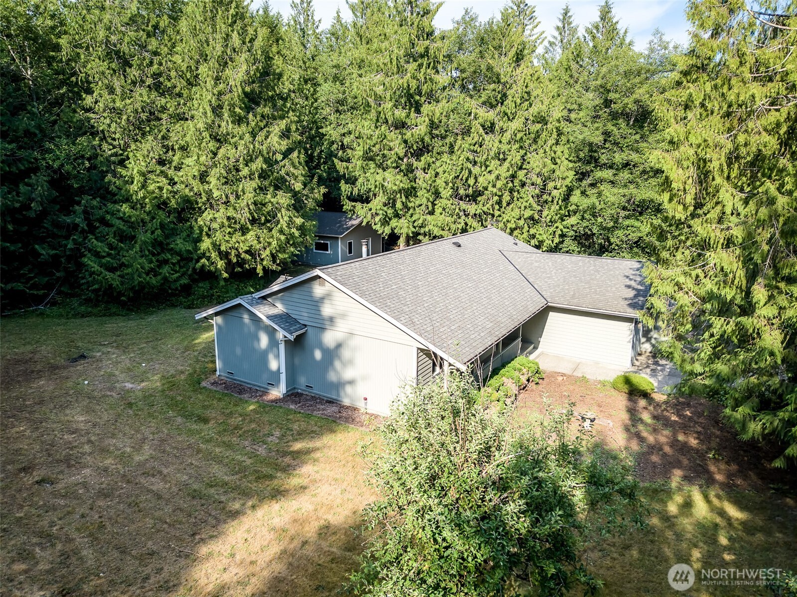660 Peter Hagen Road West Seabeck, WA 98380 - Photo 38 of 39 an aerial view of a house with yard and trees in the background