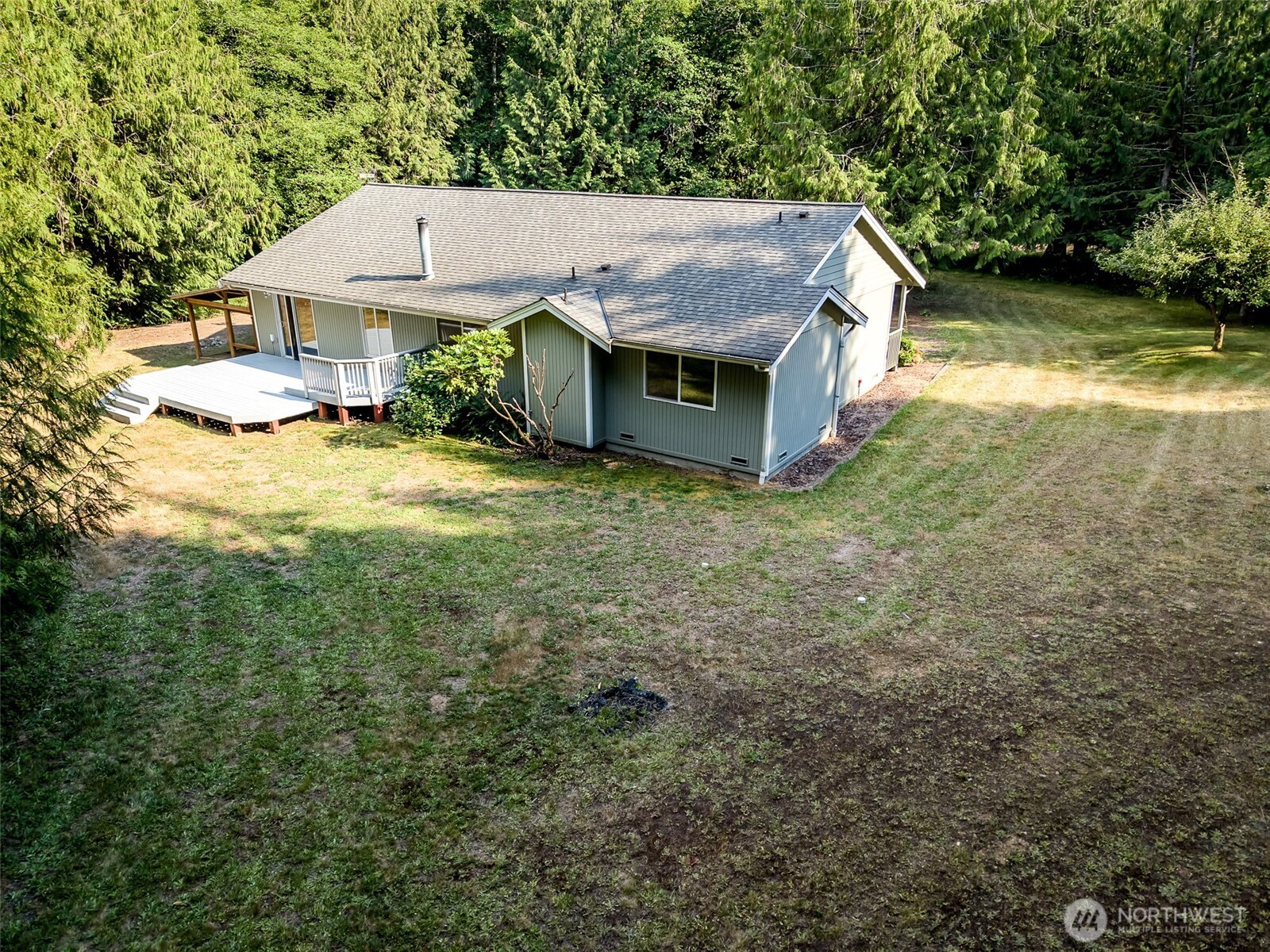 660 Peter Hagen Road West Seabeck, WA 98380 - Photo 39 of 39 an aerial view of a house with yard and trees in the background