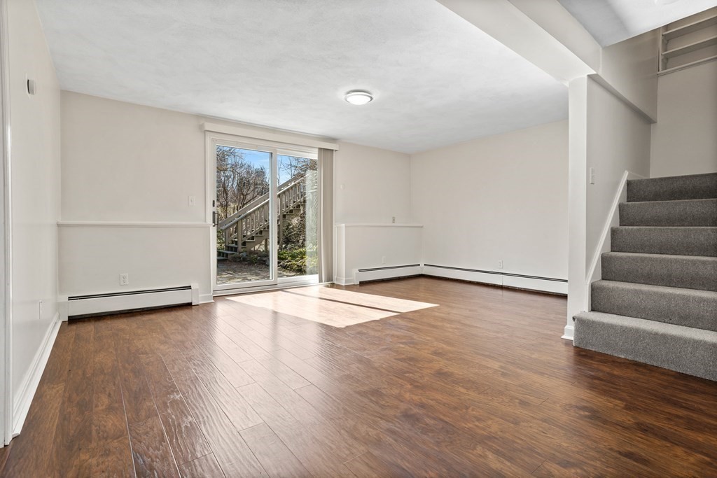 62 Westcott Road Harvard, MA 01451 - Photo 29 of 42 a view of an empty room with wooden floor and window