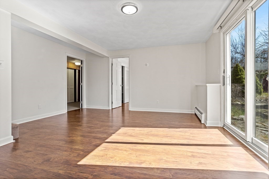 62 Westcott Road Harvard, MA 01451 - Photo 30 of 42 a view of an empty room with wooden floor and a window