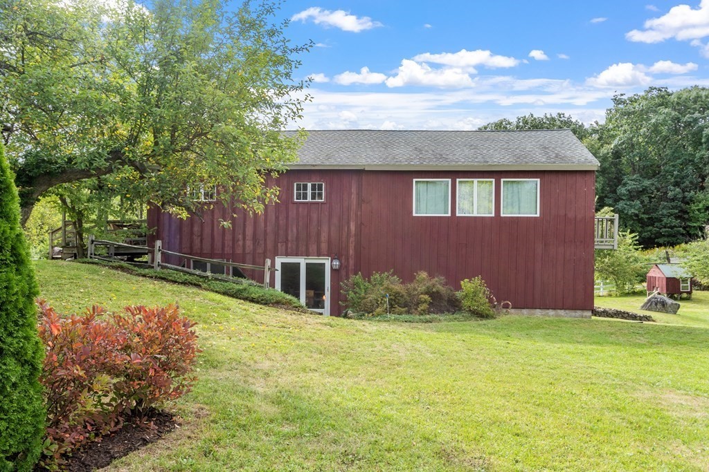 62 Westcott Road Harvard, MA 01451 - Photo 33 of 42 a view of a backyard with table and chairs and a large tree