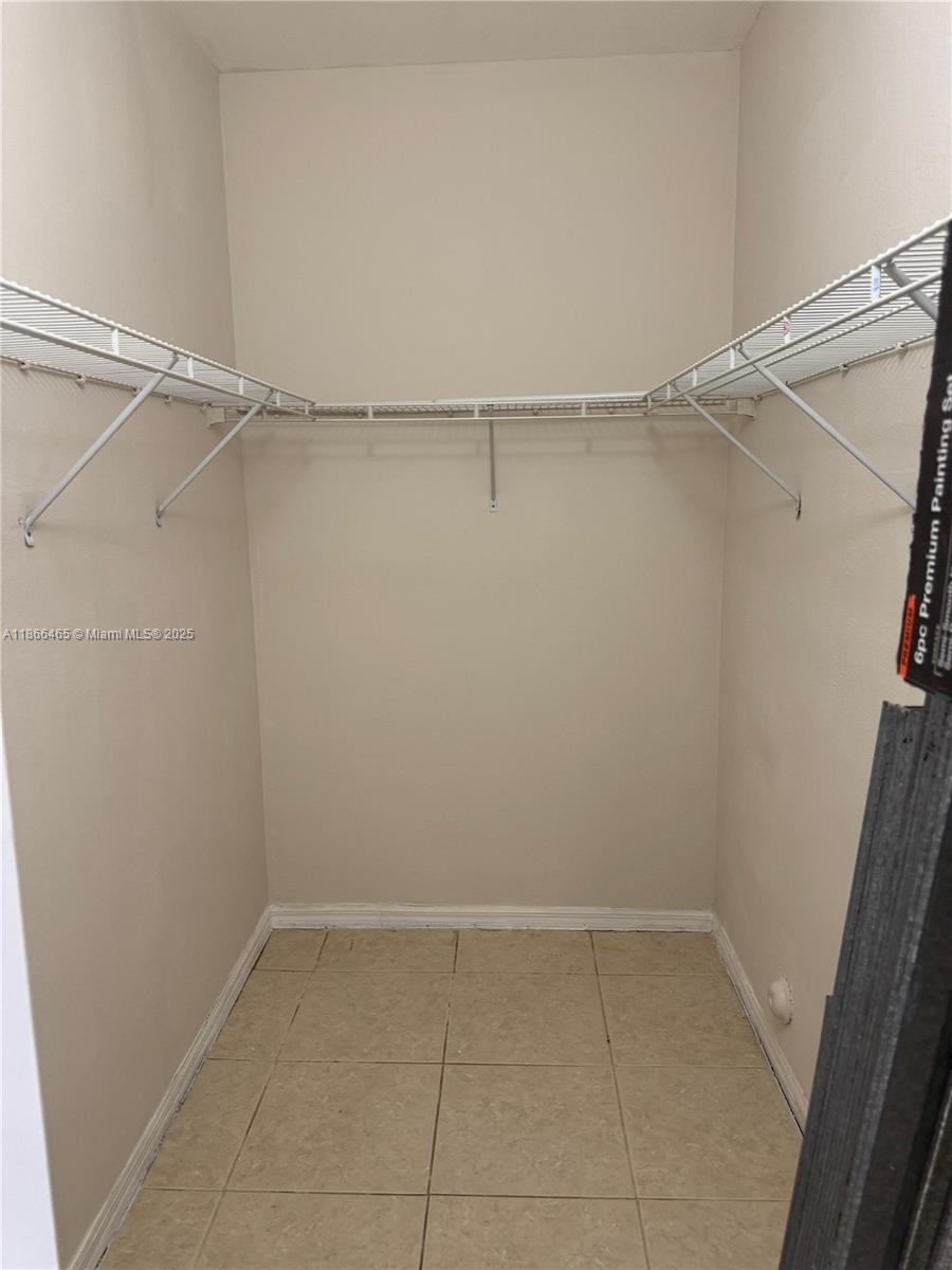 6922 Northwest 179th Street, Unit 1035 Hialeah, FL 33015 - Photo 11 of 14 a view of an empty walk in closet
