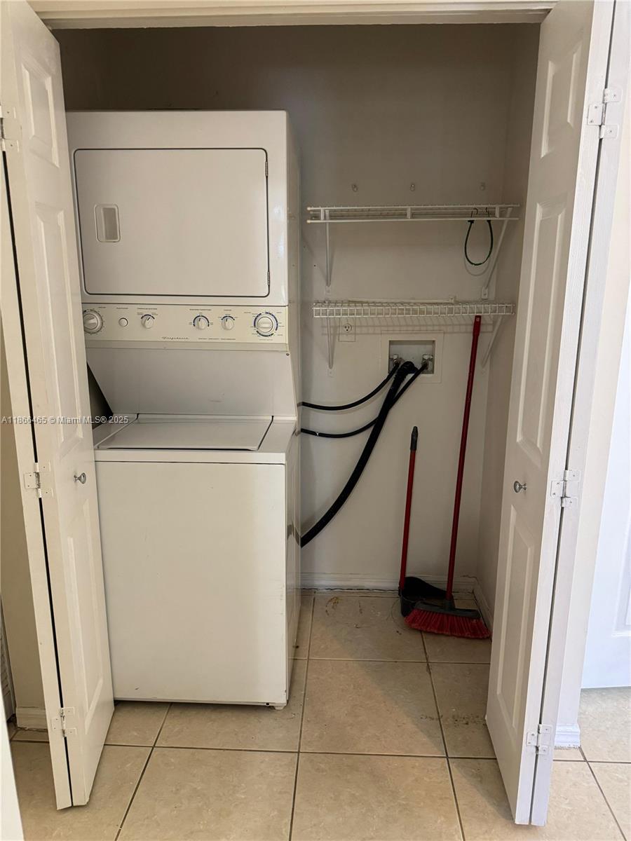 6922 Northwest 179th Street, Unit 1035 Hialeah, FL 33015 - Photo 13 of 14 a utility room with dryer and washer