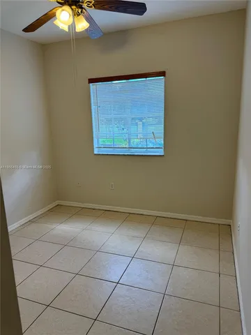 a view of an empty room with a fan
