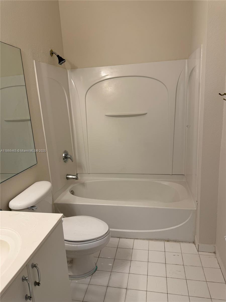 6922 Northwest 179th Street, Unit 1035 Hialeah, FL 33015 - Photo 8 of 14 a bathroom with a toilet a sink and shower