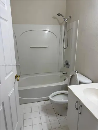 a bathroom with a toilet sink and shower
