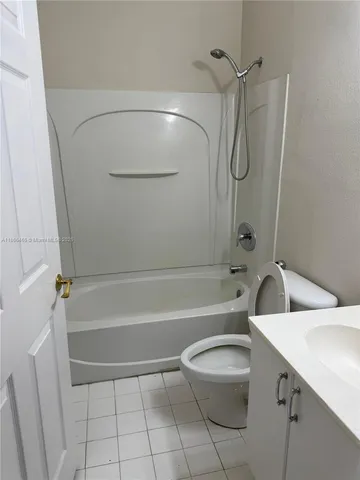 a bathroom with a toilet sink and shower