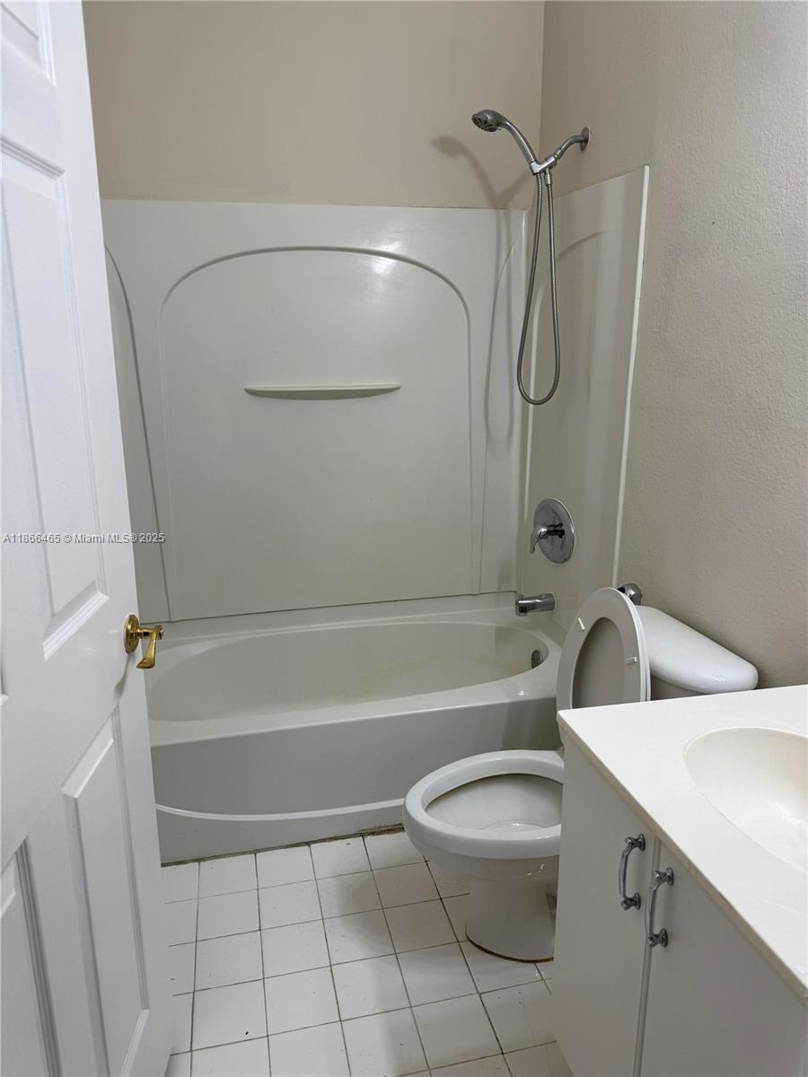 6922 Northwest 179th Street, Unit 1035 Hialeah, FL 33015 - Photo 9 of 14 a bathroom with a toilet sink and shower
