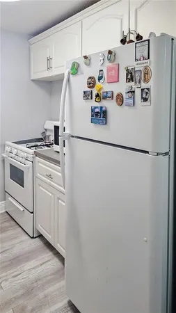 a white refrigerator freezer sitting inside of a kitchen