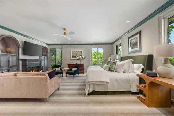 a living room with furniture a fireplace and a large window