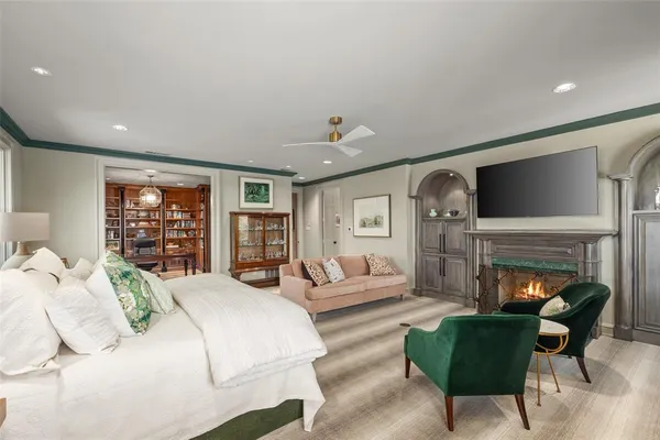 a bedroom with furniture and a fireplace