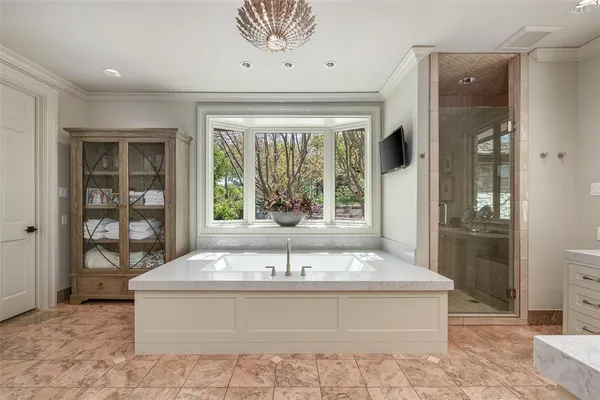 a spacious bathroom with a tub and shower