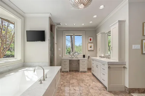 a large spacious bathroom with a large tub and sink