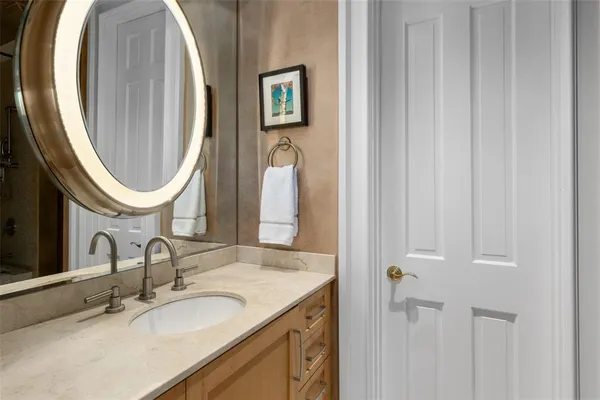 a bathroom with a double vanity sink and a mirror