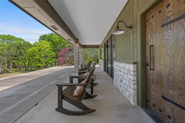 a view of a porch with chairs and backyard