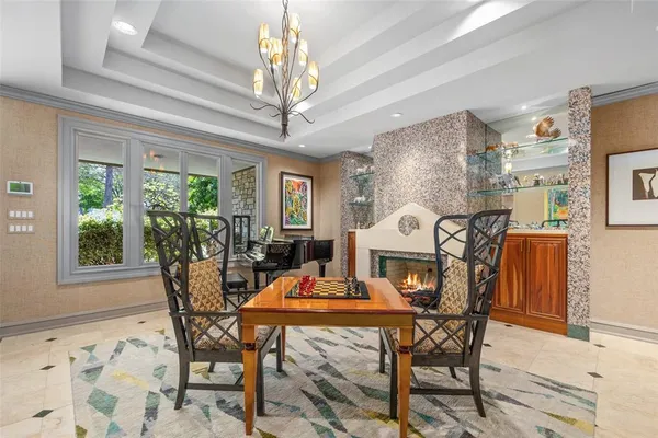 a view of a dining room with furniture and a chandelier