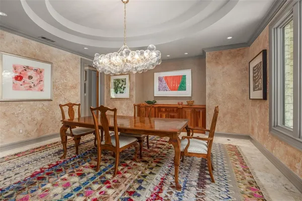 a view of a dining room with furniture a chandelier and wooden floor