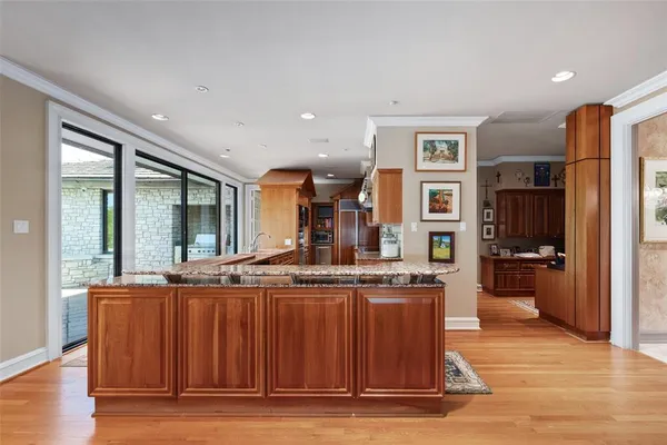 a view of kitchen with stainless steel appliances granite countertop sink stove and refrigerator
