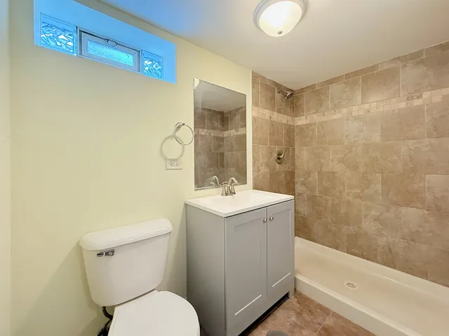 a bathroom with a sink mirror toilet and bathtub