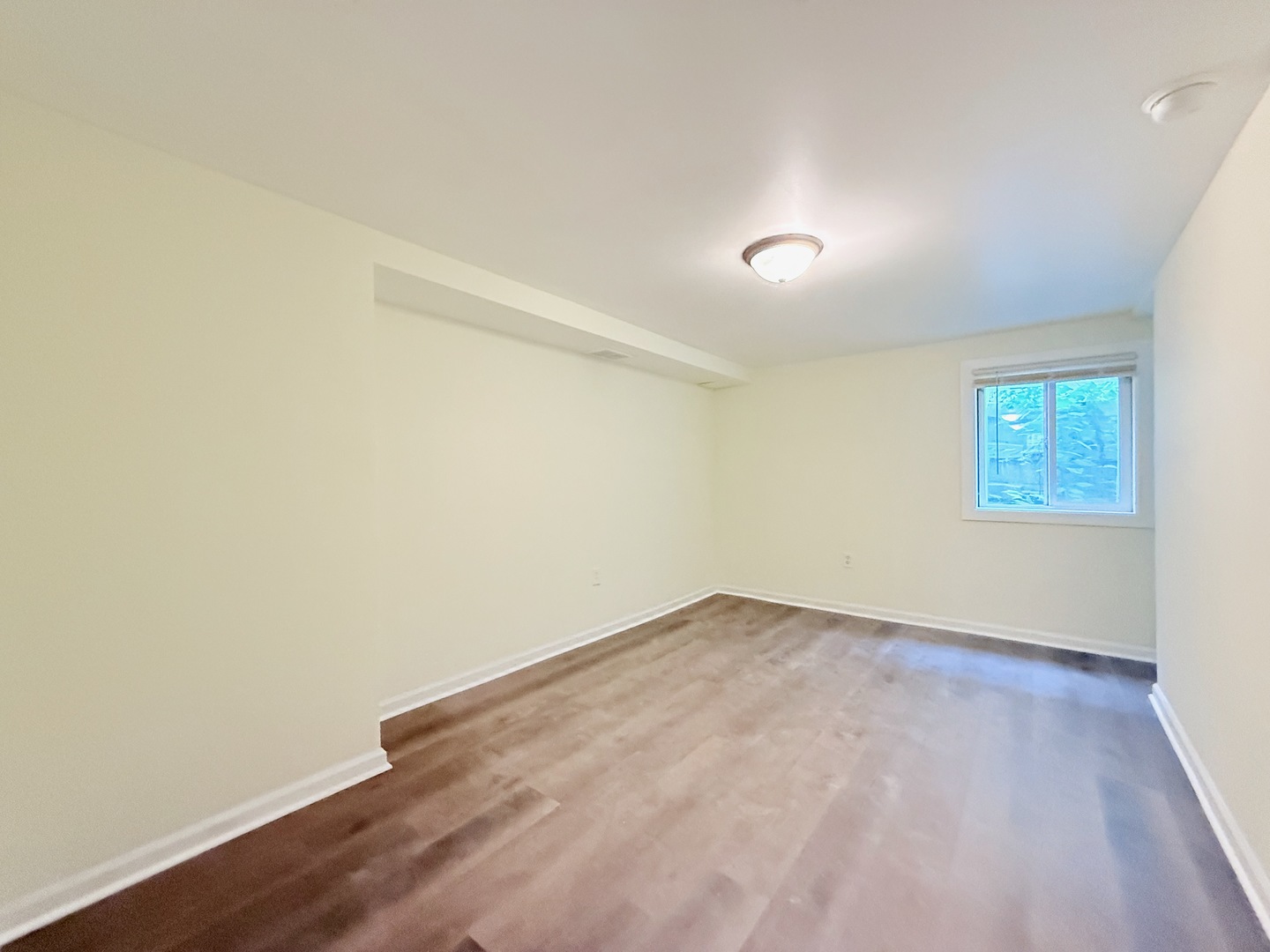 17511 Maple Avenue Lansing, IL 60438 - Photo 18 of 24 an empty room with wooden floor and windows