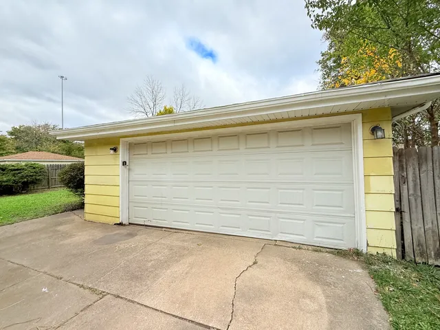 a side view of a house with a garage