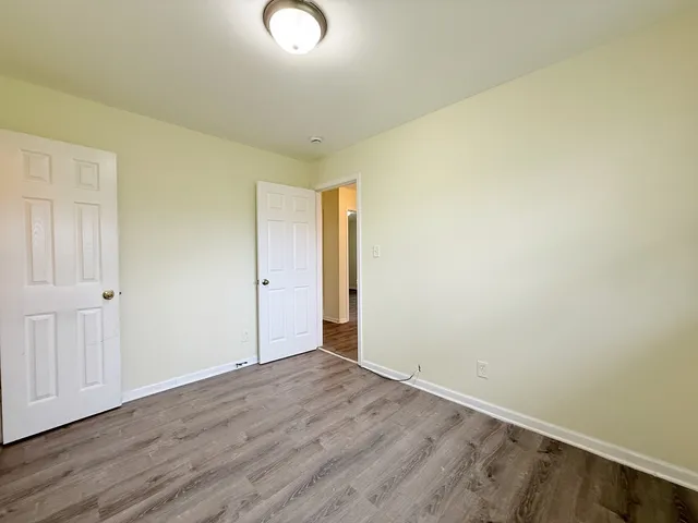 an empty room with wooden floor