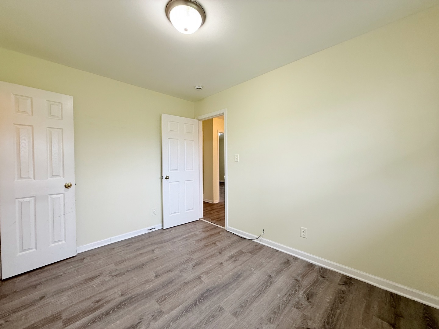17511 Maple Avenue Lansing, IL 60438 - Photo 6 of 24 an empty room with wooden floor