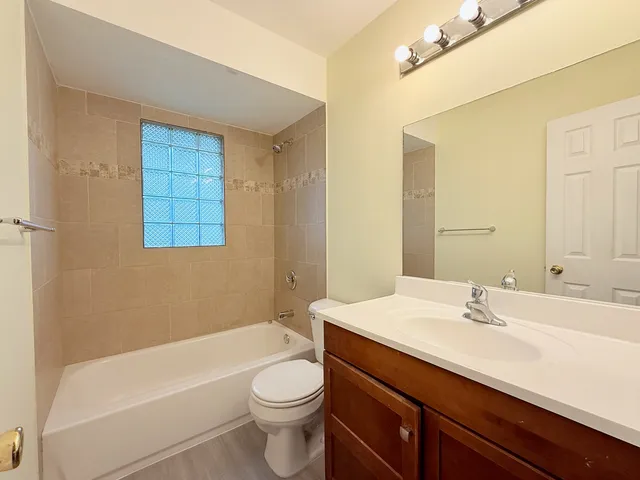 a bathroom with a sink a toilet and bathtub