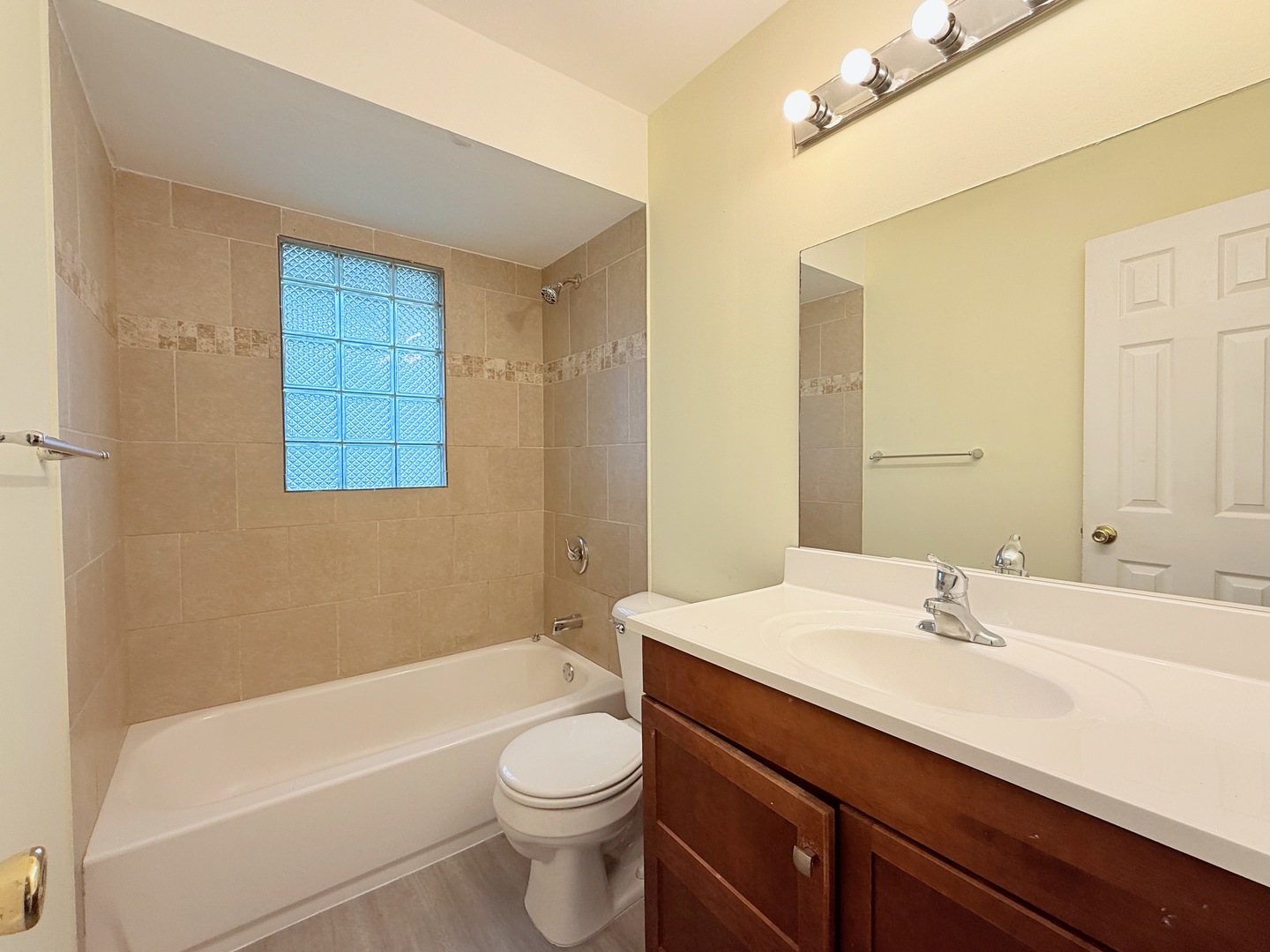 17511 Maple Avenue Lansing, IL 60438 - Photo 7 of 24 a bathroom with a sink a toilet and bathtub