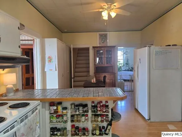 a kitchen with stainless steel appliances granite countertop a sink and a refrigerator