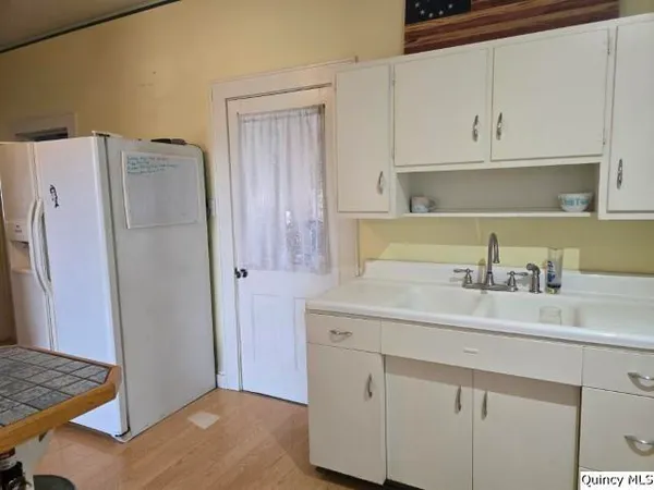 a kitchen with a sink and refrigerator