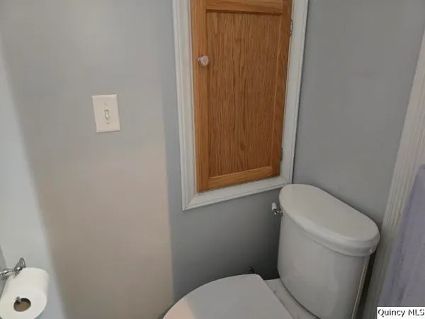a white toilet sitting next to a bathroom sink