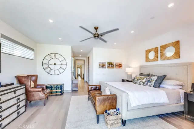 a bedroom with furniture and a large window