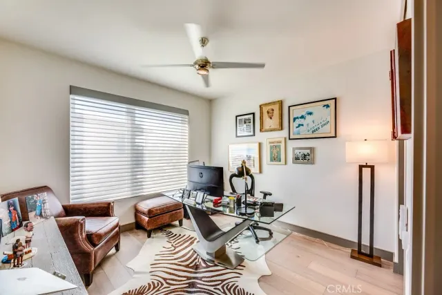 a living room with furniture a window and a flat screen tv