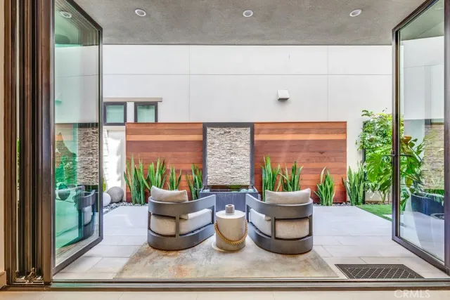 a living room with furniture and a potted plant