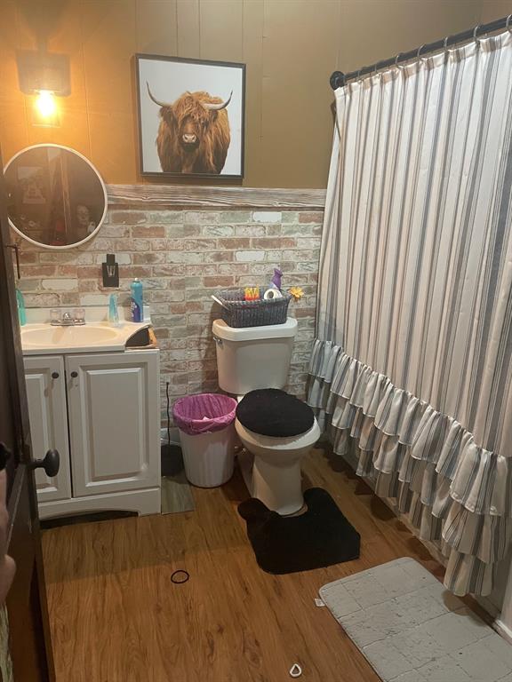 918 West Angeline Street Groesbeck, TX 76642 - Photo 6 of 8 a bathroom with a toilet and a sink