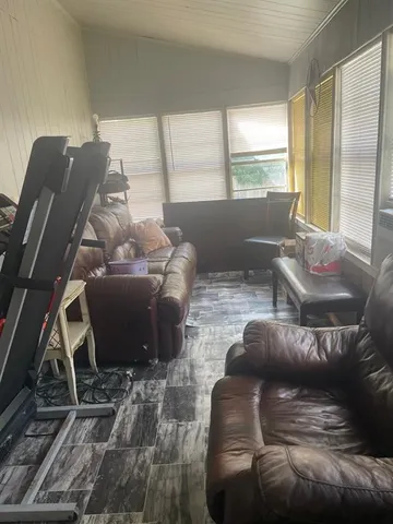 a living room with furniture and a floor to ceiling window