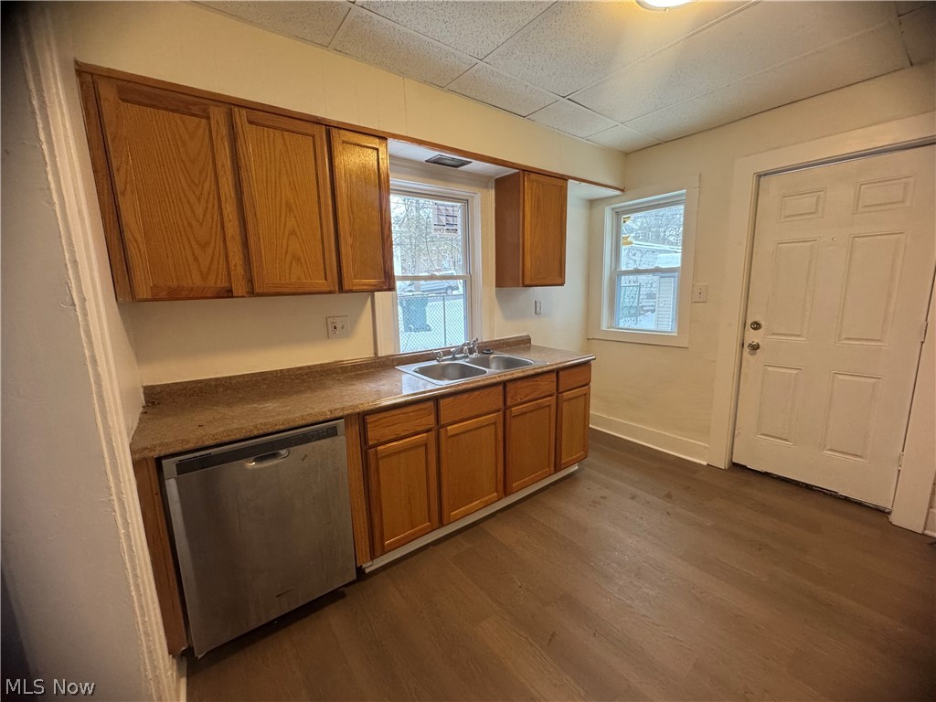 3242 Sycamore Road, Unit LEFT SIDE Cleveland Heights, OH 44118 - Photo 7 of 20 Kitchen with stainless steel dishwasher, dark wood finished floors, wood finish cabinets, and dark countertops