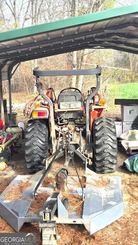 a view of a dry yard with trees