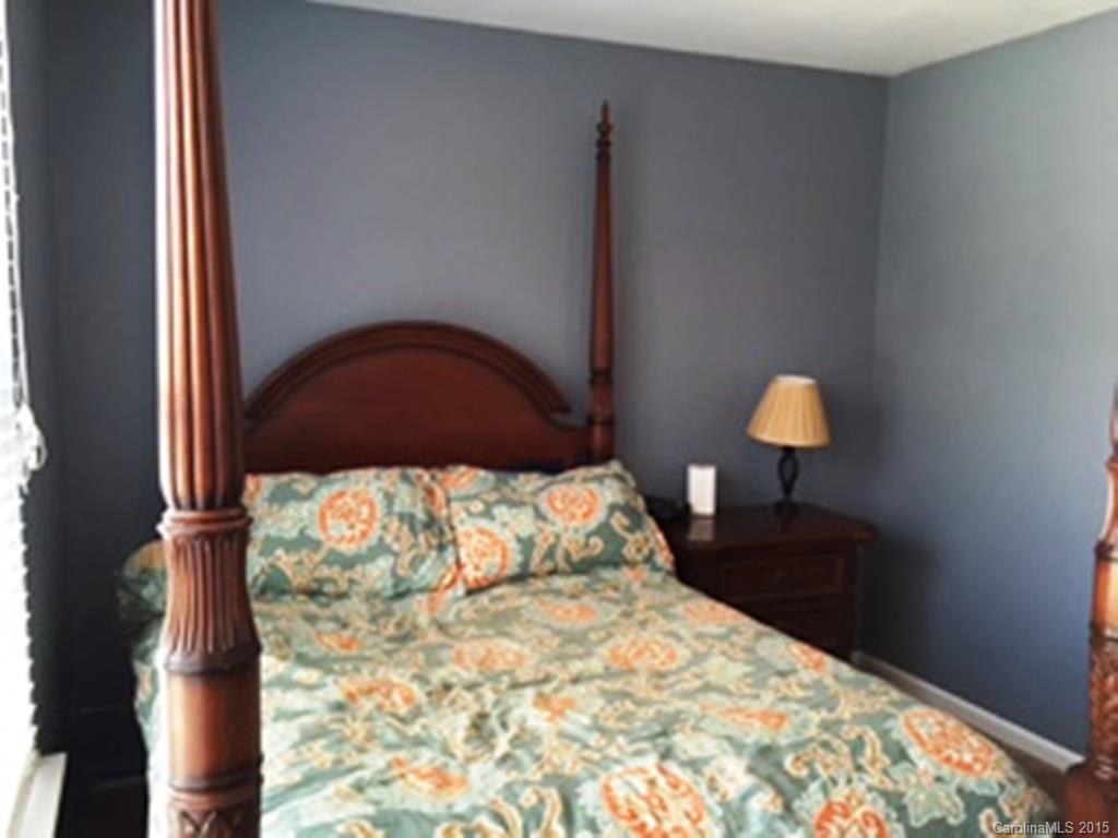 846 Gentlewinds Court, Unit 132 Fort Mill, SC 29708 - Photo 11 of 14 a bedroom with a bed and a lamp on dresser