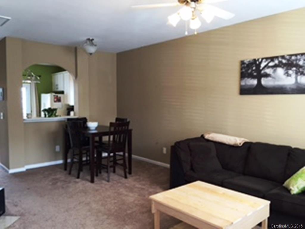 846 Gentlewinds Court, Unit 132 Fort Mill, SC 29708 - Photo 4 of 14 a living room with furniture and a dining table
