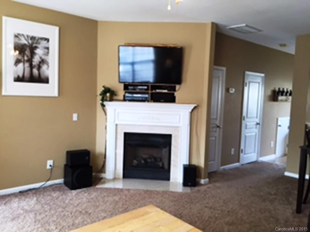 846 Gentlewinds Court, Unit 132 Fort Mill, SC 29708 - Photo 5 of 14 a living room with furniture a fireplace and a flat screen tv