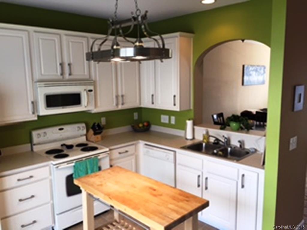 846 Gentlewinds Court, Unit 132 Fort Mill, SC 29708 - Photo 6 of 14 a kitchen with stainless steel appliances a stove a sink a cabinets and a microwave
